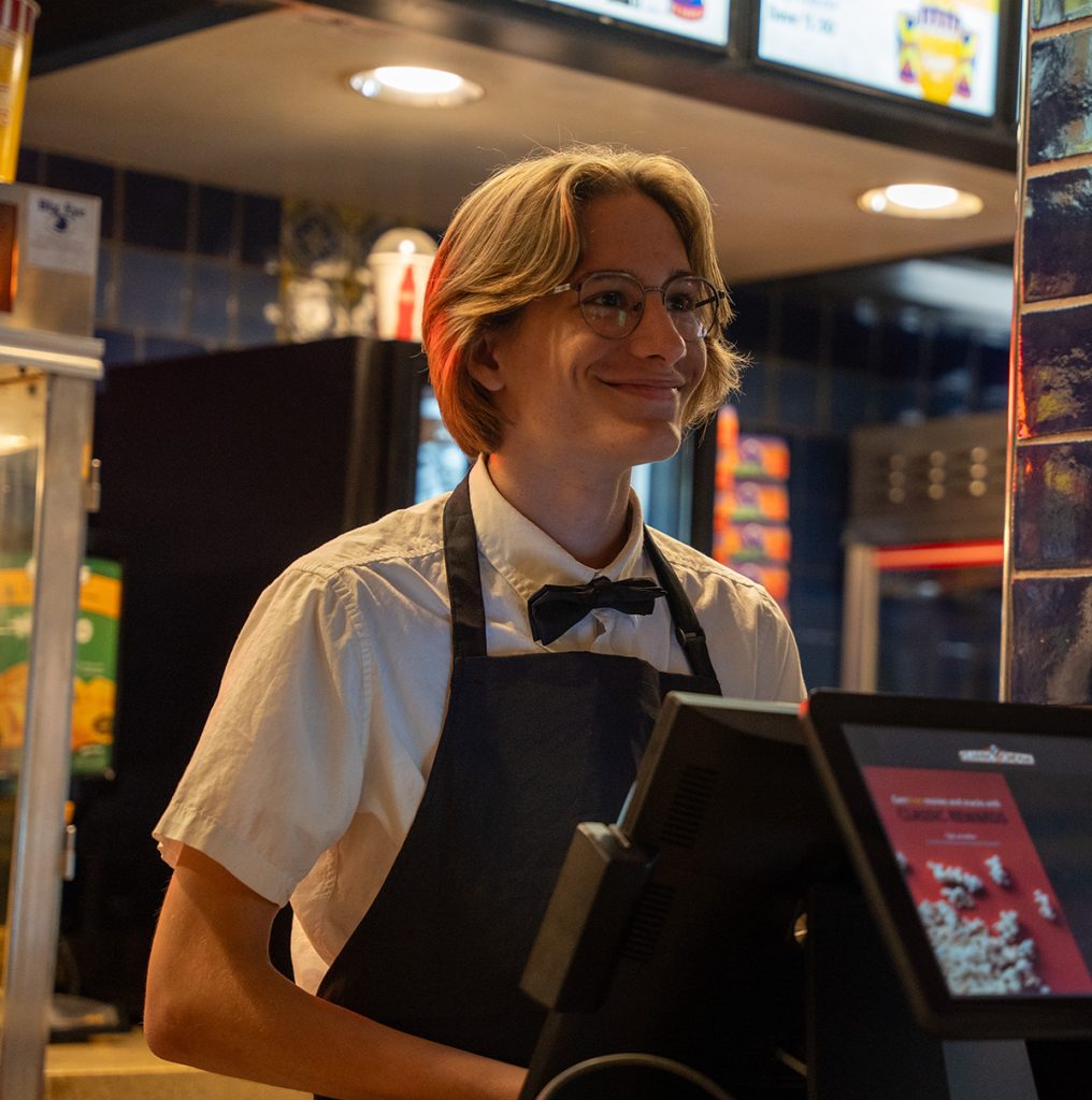 theater employee smiling behind register