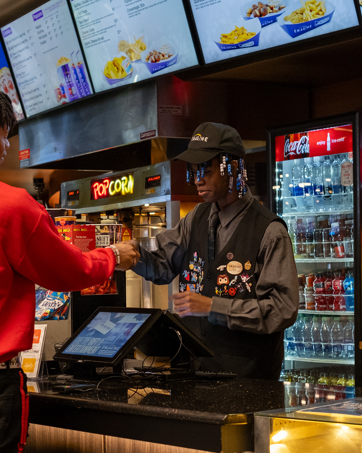 cinema concessions worker completing a transaction