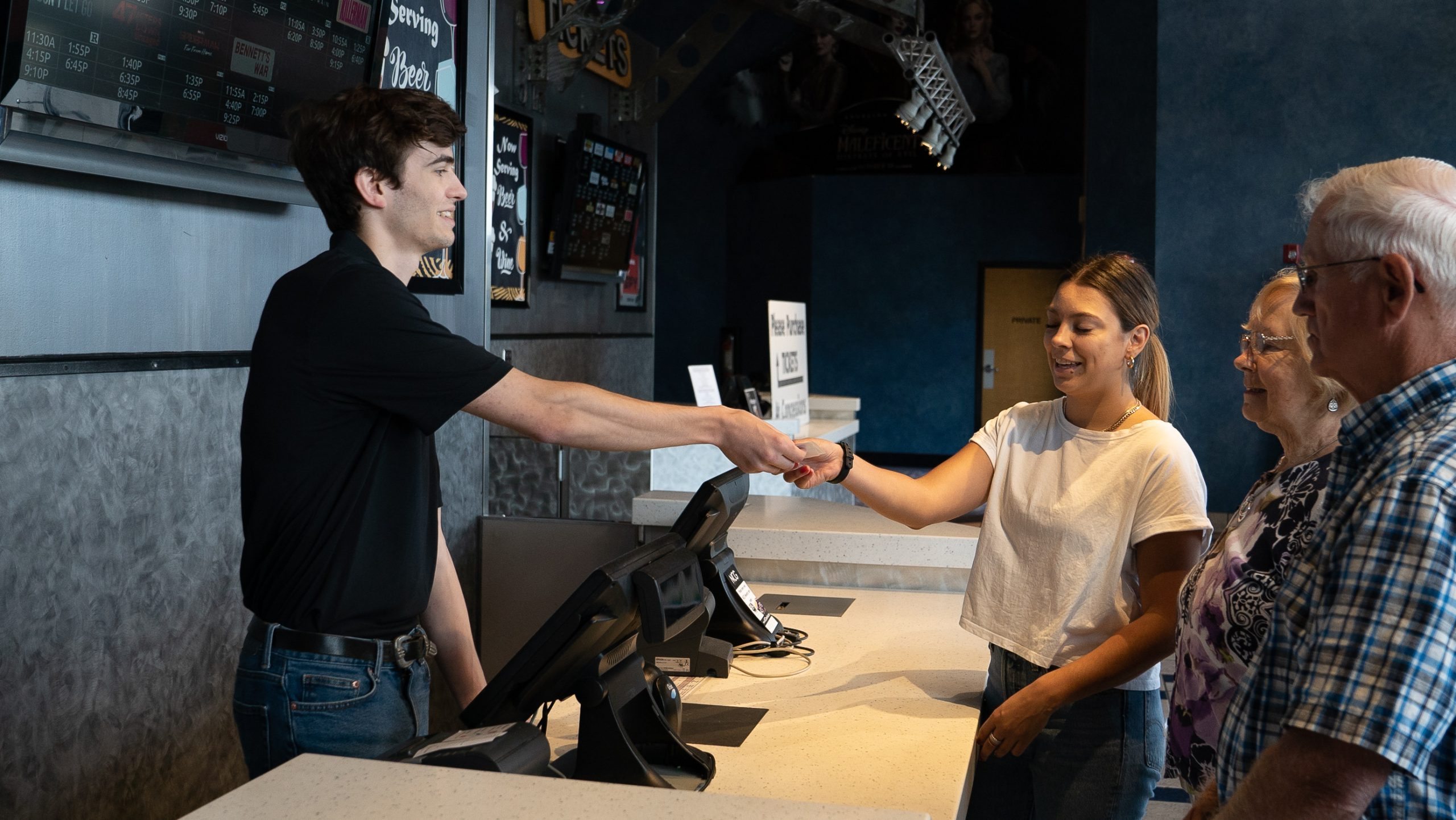 employee behind counter handing customer a receipt