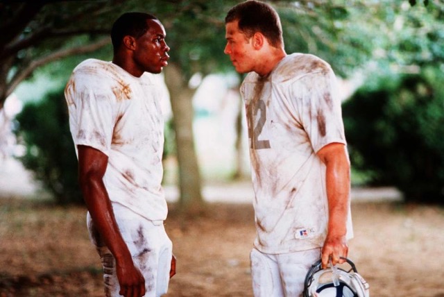 two football players standing facing each other engaged in a tense conversation