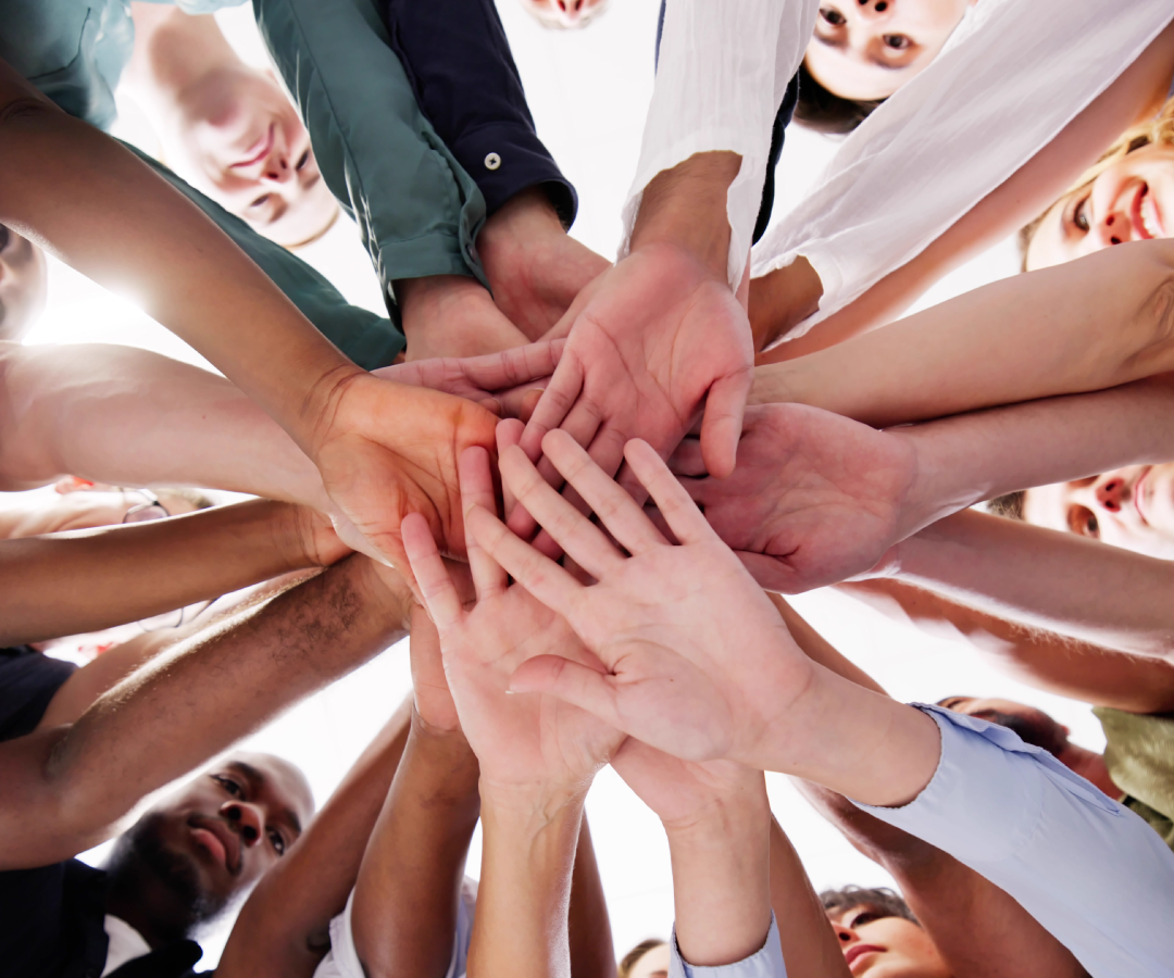 various hands all meeting in the center together