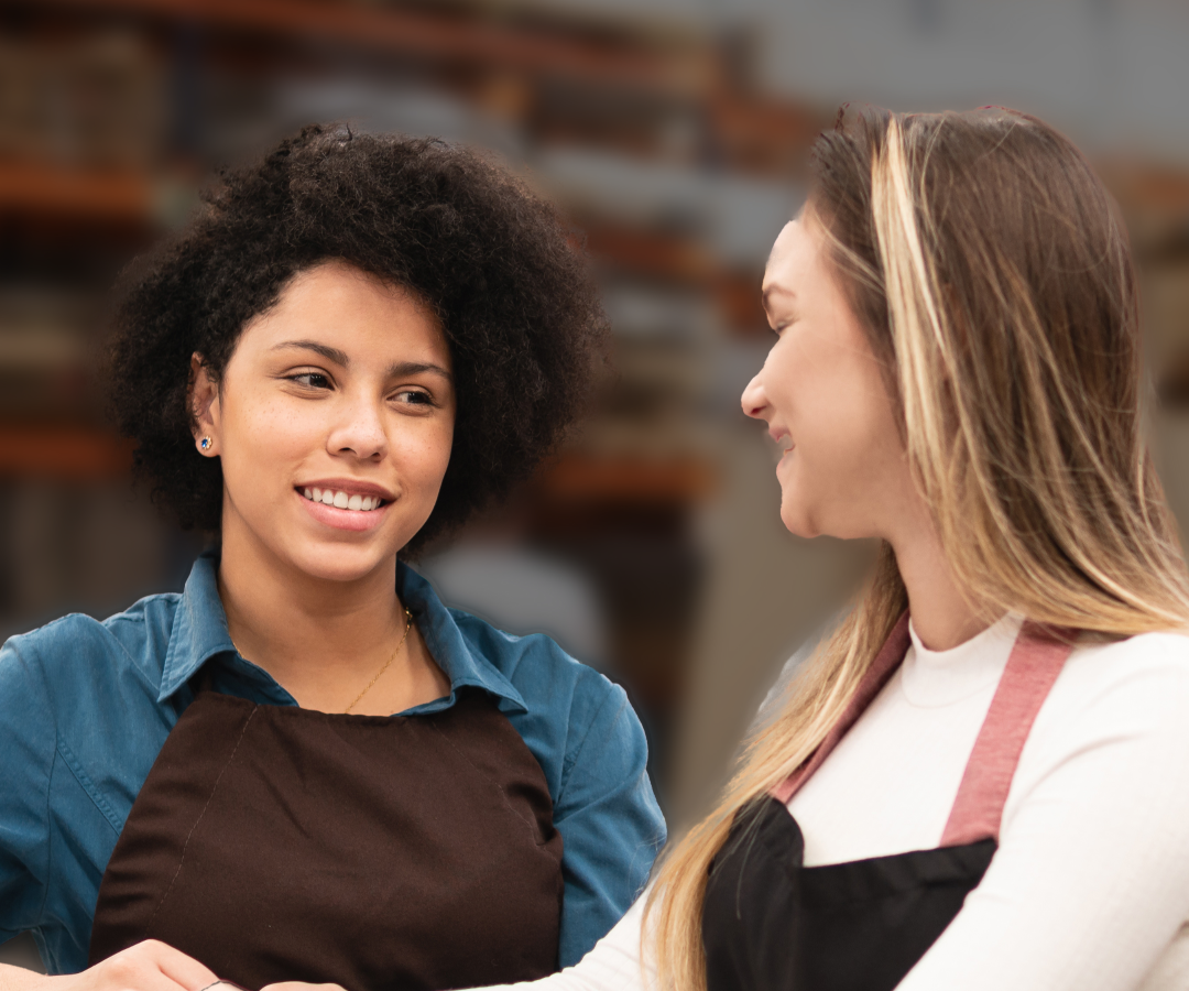 two women looking at each other smiling